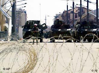 French soldier of the NATO-led peace troops guard the bridge in the northern Kosovo city of Kosovska Mitrovica, Friday, March 19, 2004.