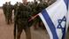 Israeli soldiers, one holding an Israeli flag