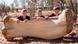 Students pose for photos with a replica of femur from the Australotitan cooperensis in Eromanga, Queensland, Australia