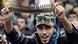 Anti-Libyan Leader Moammar Gadhafi protester, holds up bullets during a protest after Friday prayer at the court square, in Benghazi, eastern Libya, Friday March 4, 2011